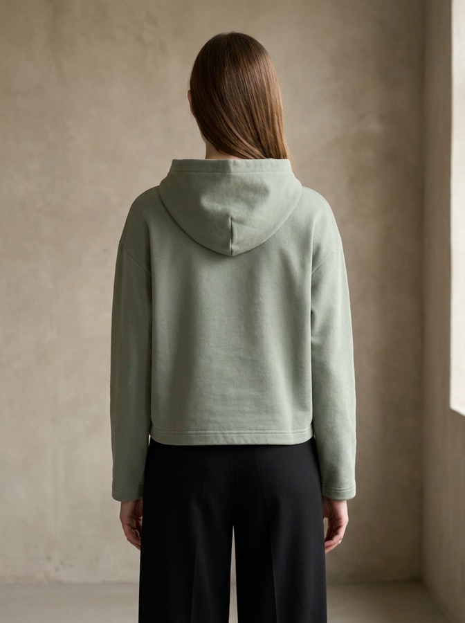 Sage hoodie worn by a model, back view
